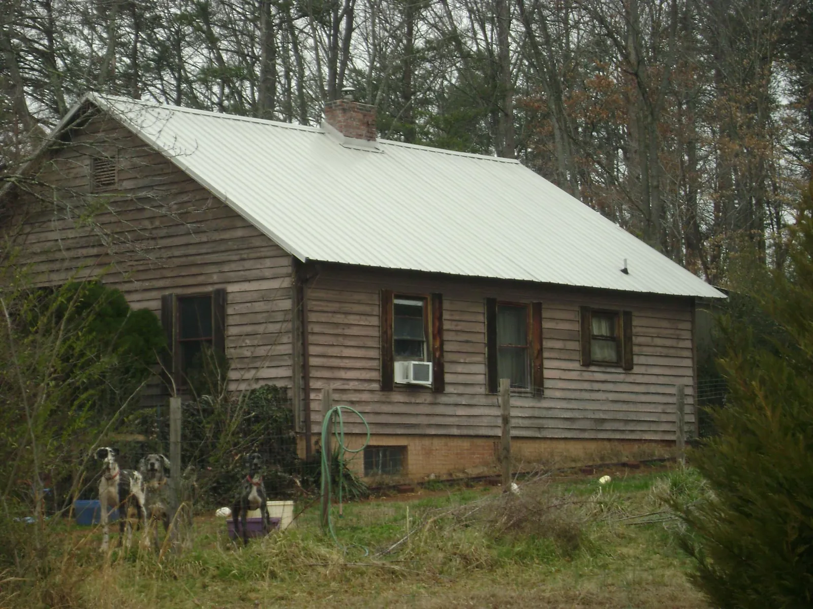 White metal roof on an old wood sided farmhouse, from a Metal Roof Installation job in Scales Mound